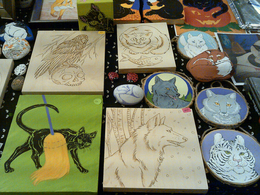 My creepy horror and Halloween wares. Note the big, hairy spiders and creepy dollies peeping around the corners. Pieces at this show included blacklight art, lots of black cat art and classic horror-genre actor paintings.